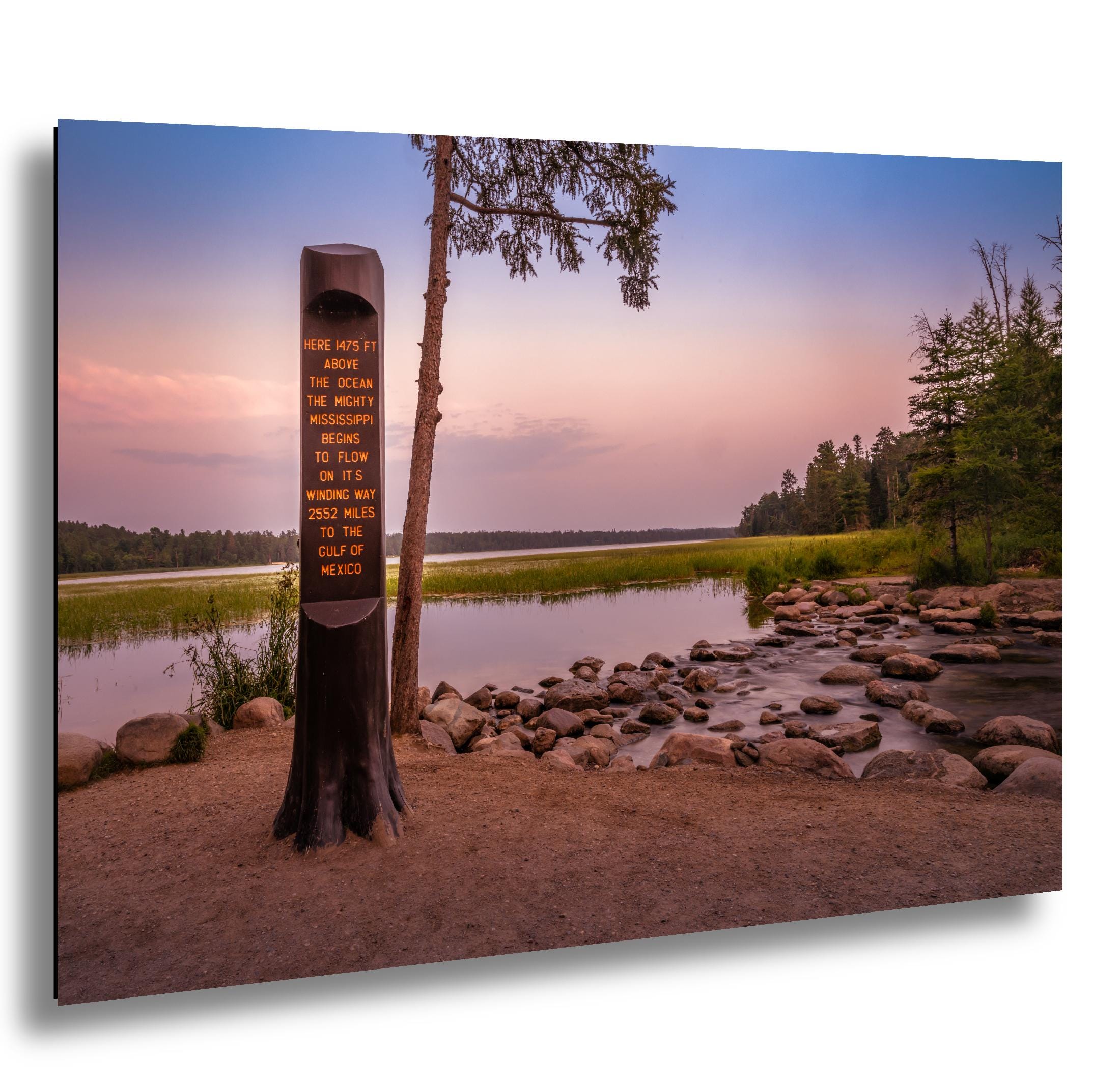 Mississippi River headwaters sign at sunset in Itasca State Park, Minnesota