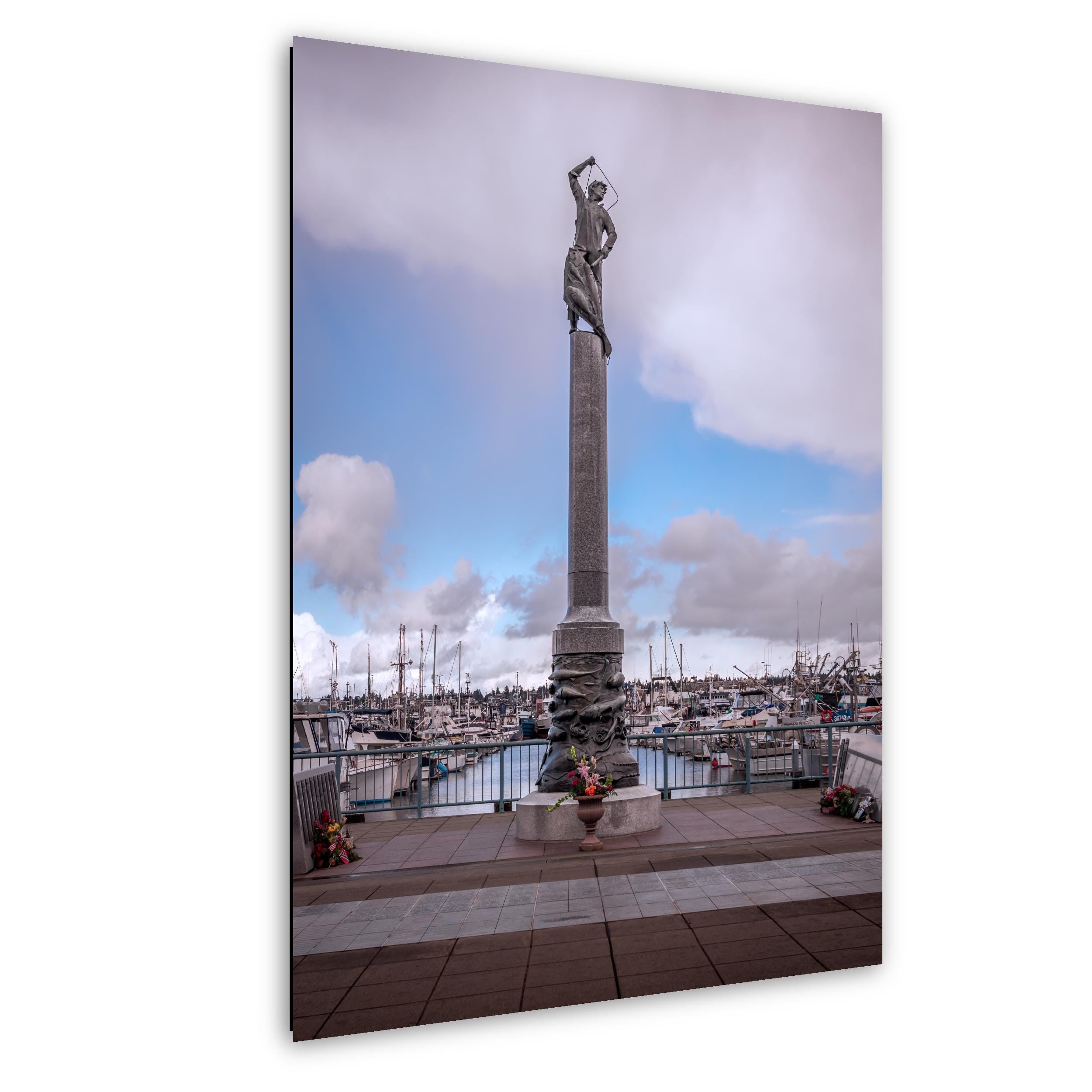 Seattle Fishermen’s Terminal memorial statue with harbor boats under soft skies