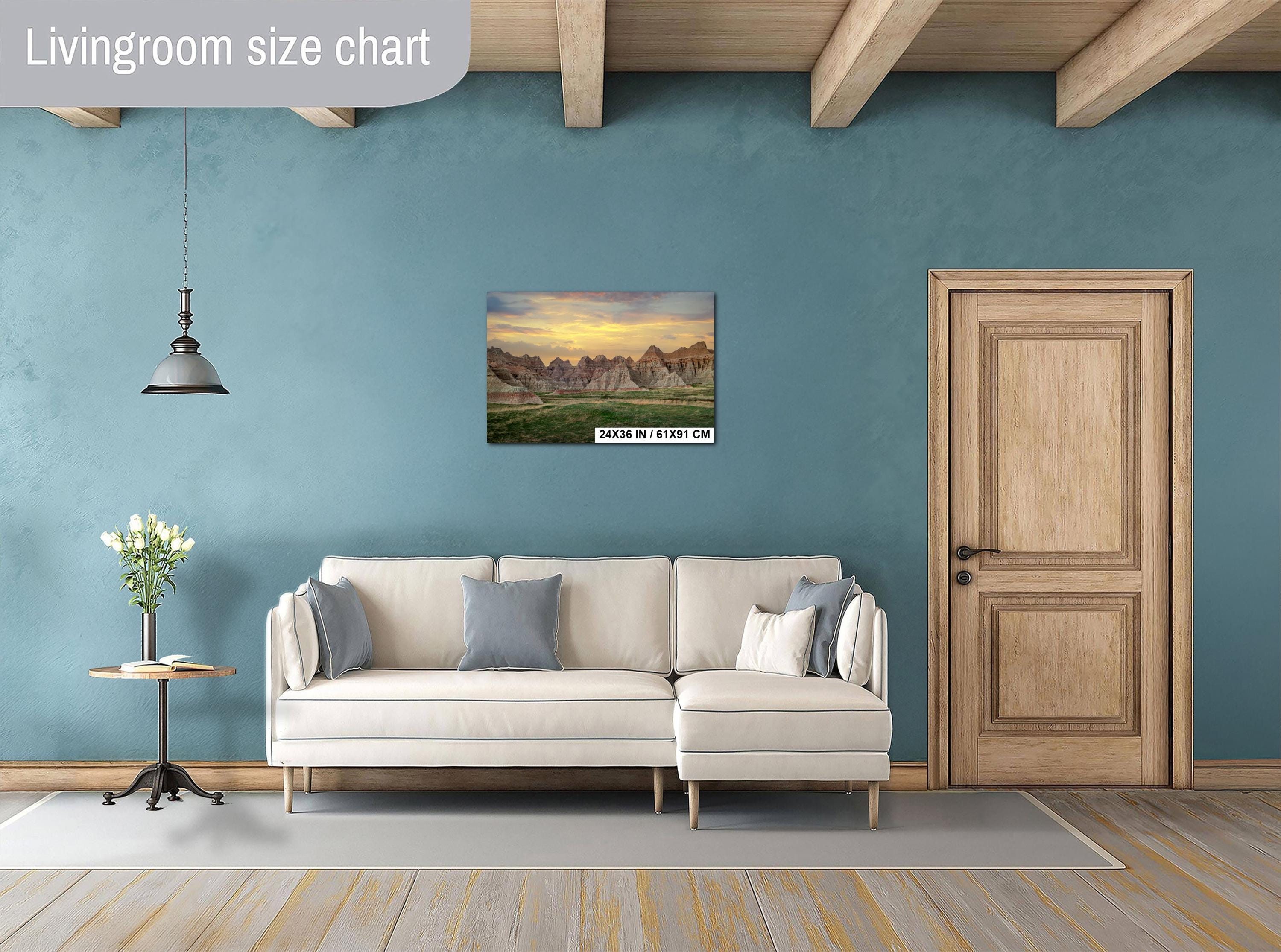Living room with a beige sectional sofa, side table, and wall art on a blue wall.