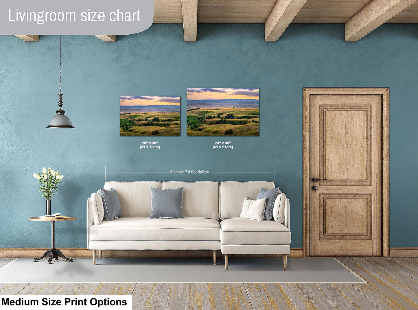 Living room with a sofa, side table, and two wall art prints on a blue wall.