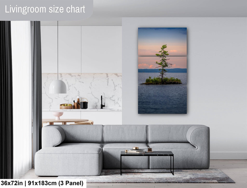 Living room with a large wall art of a tree on an island, gray sectional sofa, and coffee table.