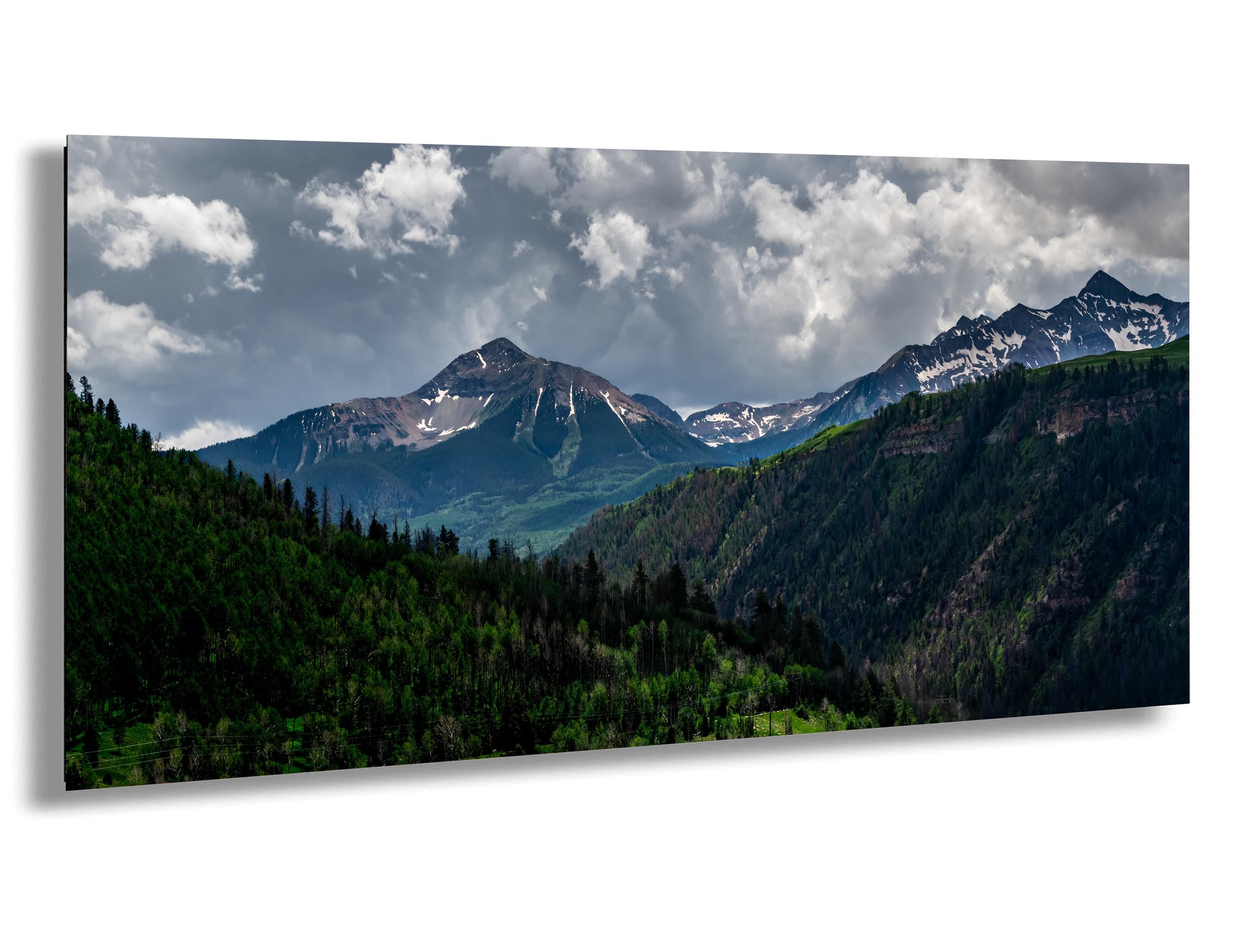 Stormy sky over San Juan Mountains near Telluride, Colorado with snowcapped peaks and forest view
