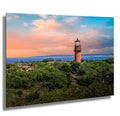 Lighthouse on a hill with a colorful sky and ocean at Martha's Vineyard