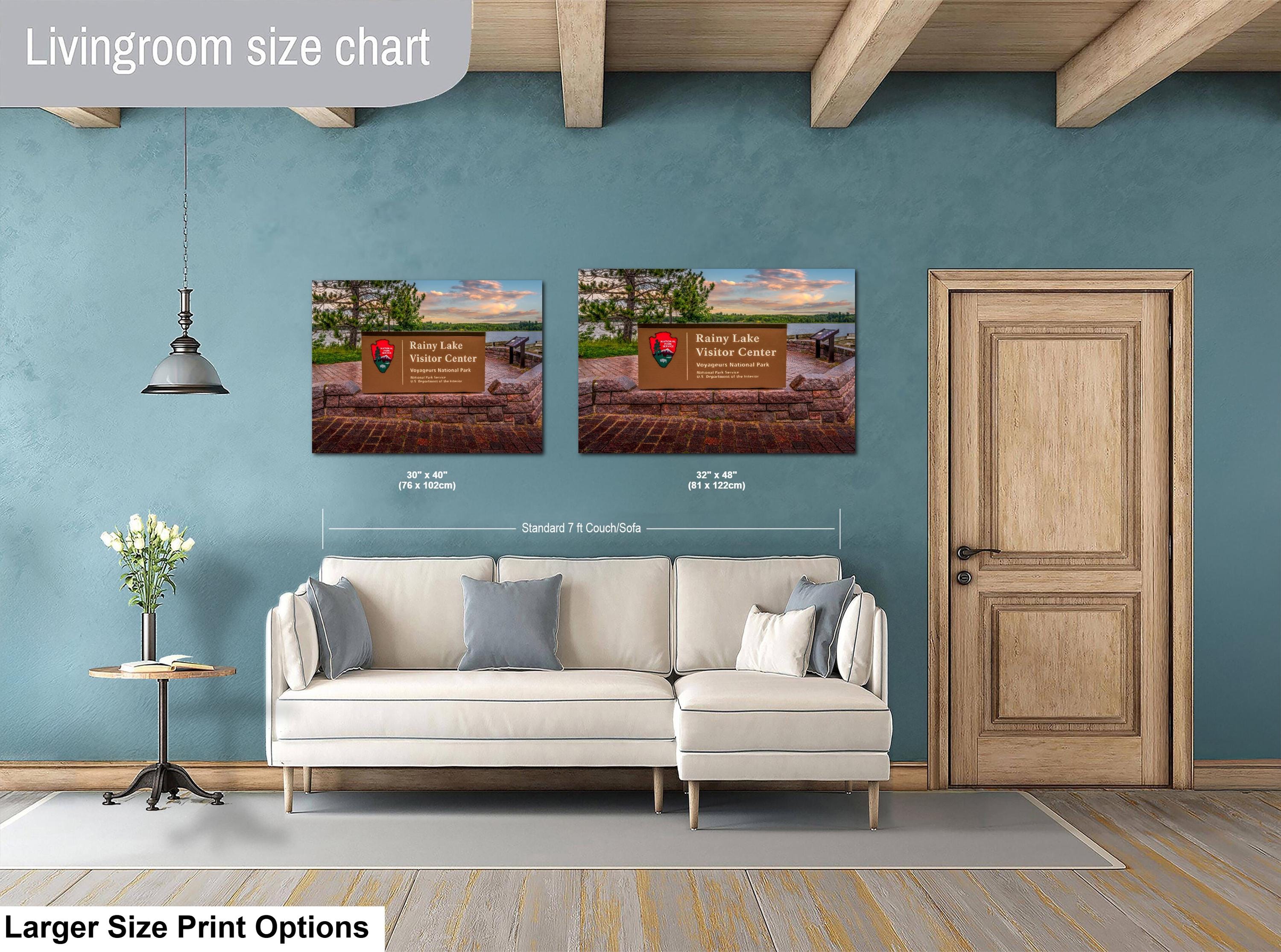 Living room with a sofa, side table, and two wall art prints on a blue wall.