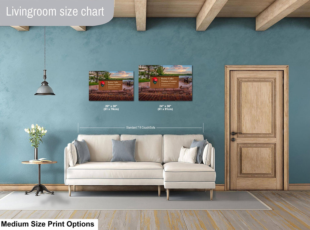 Living room with a sofa, side table, and wall art, featuring a size chart for prints.