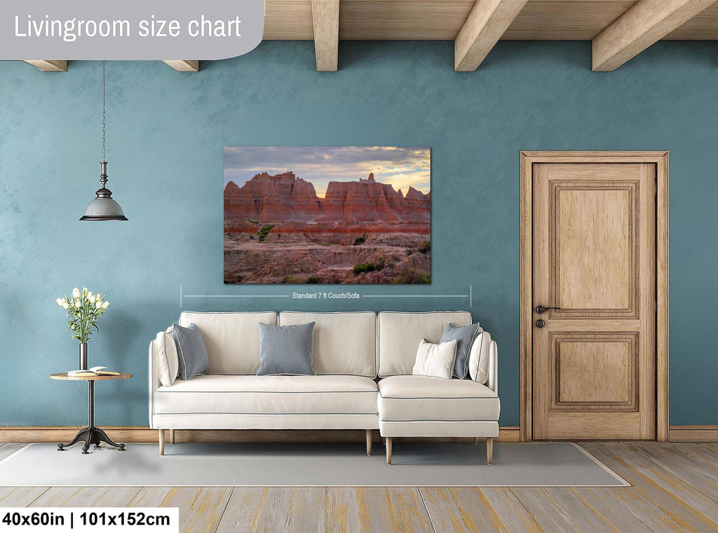Living room with a wall art displaying a nature scene, beige sofa, and wooden door.