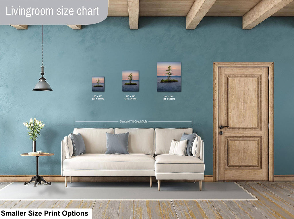 Living room with a beige sectional sofa, side table, and wall art on a blue wall.