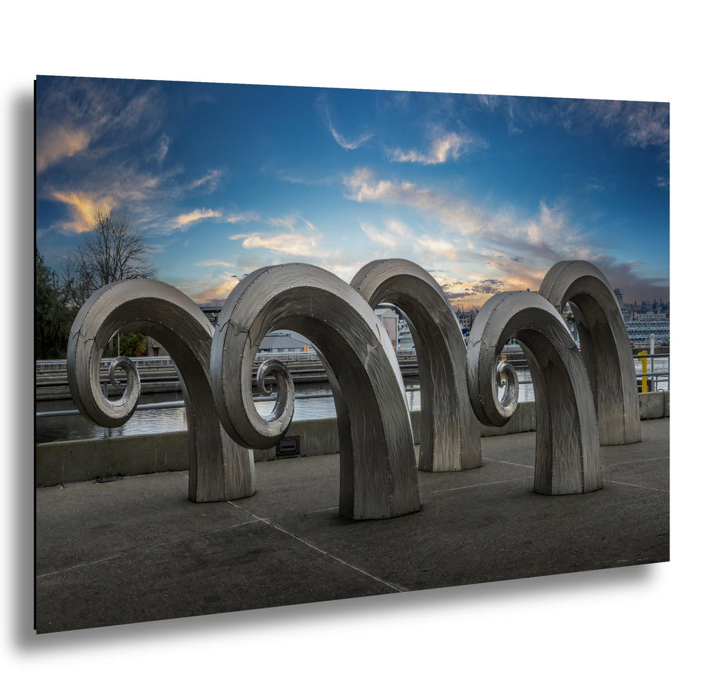 Seattle stainless steel wave sculptures at waterfront at dusk, cool blue sky
