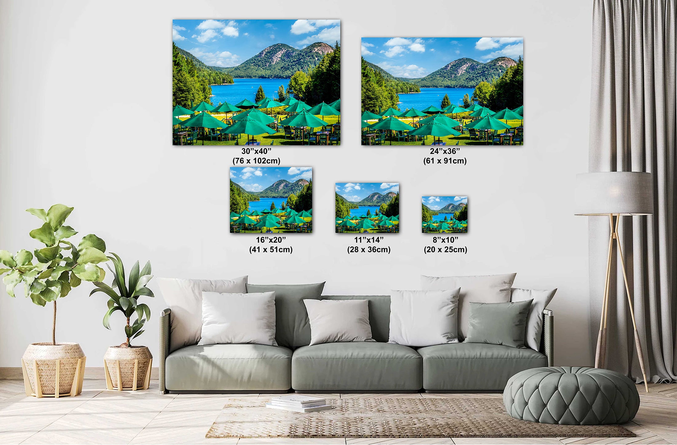 Living room with a sofa and decorative wall art depicting a scenic lake and mountains.