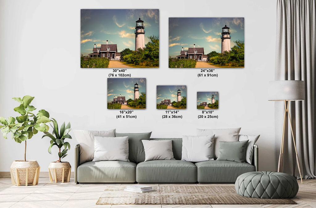 Living room with a sofa and decorative plants, featuring Cape Cod Highland Lighthouse framed wall arts.