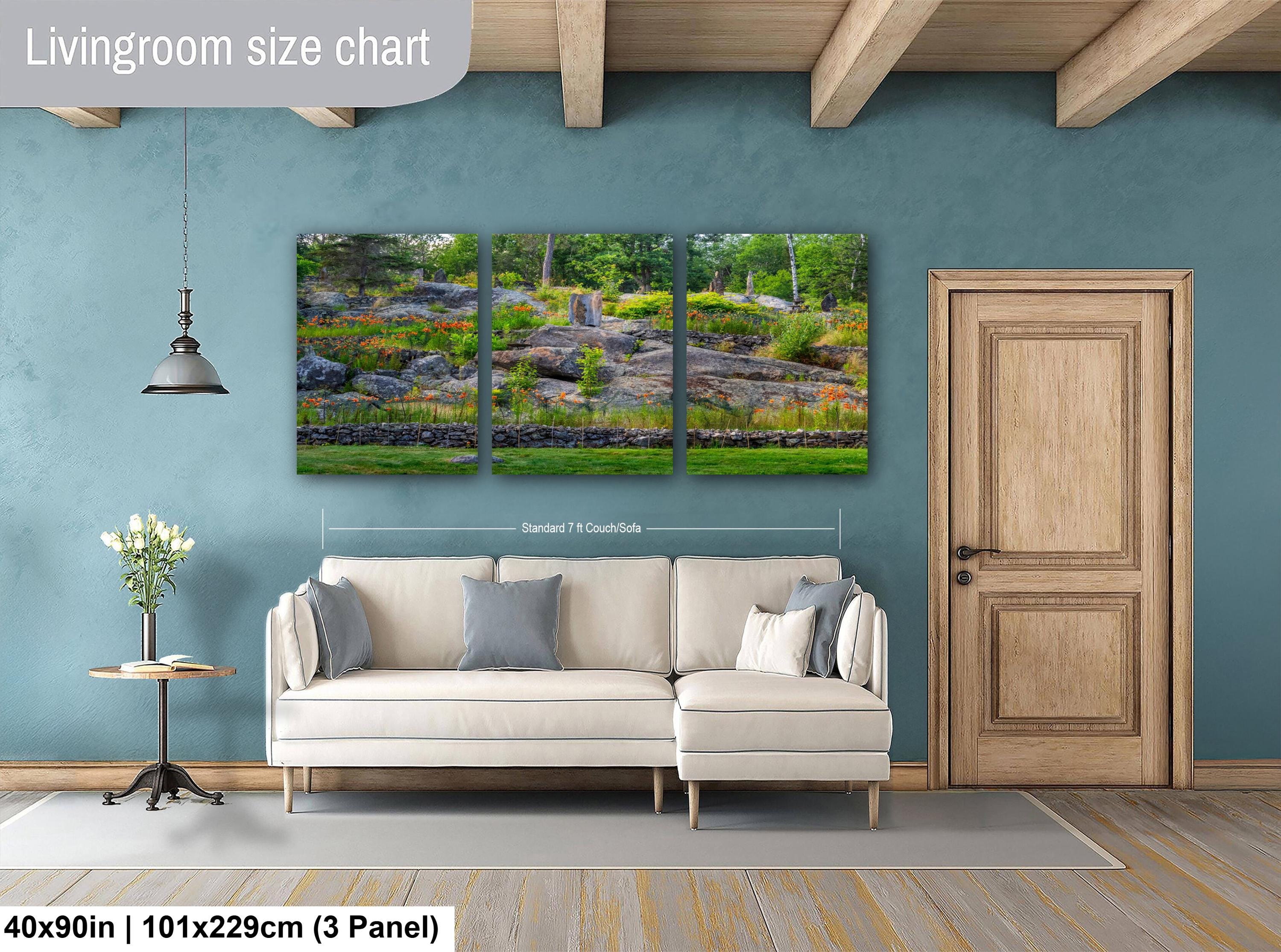 Living room with a sofa, side table, and wall art on a blue wall.