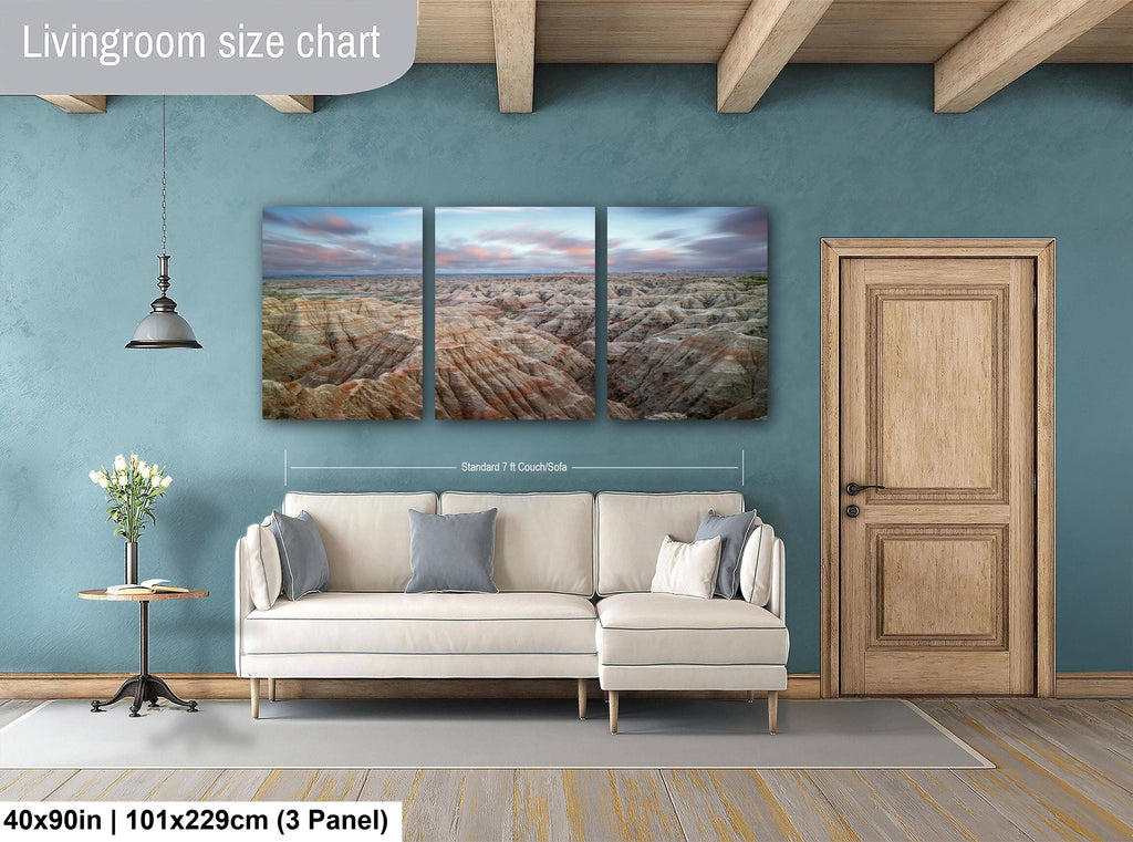 Living room with a sofa, side table, and wall art on a blue wall.