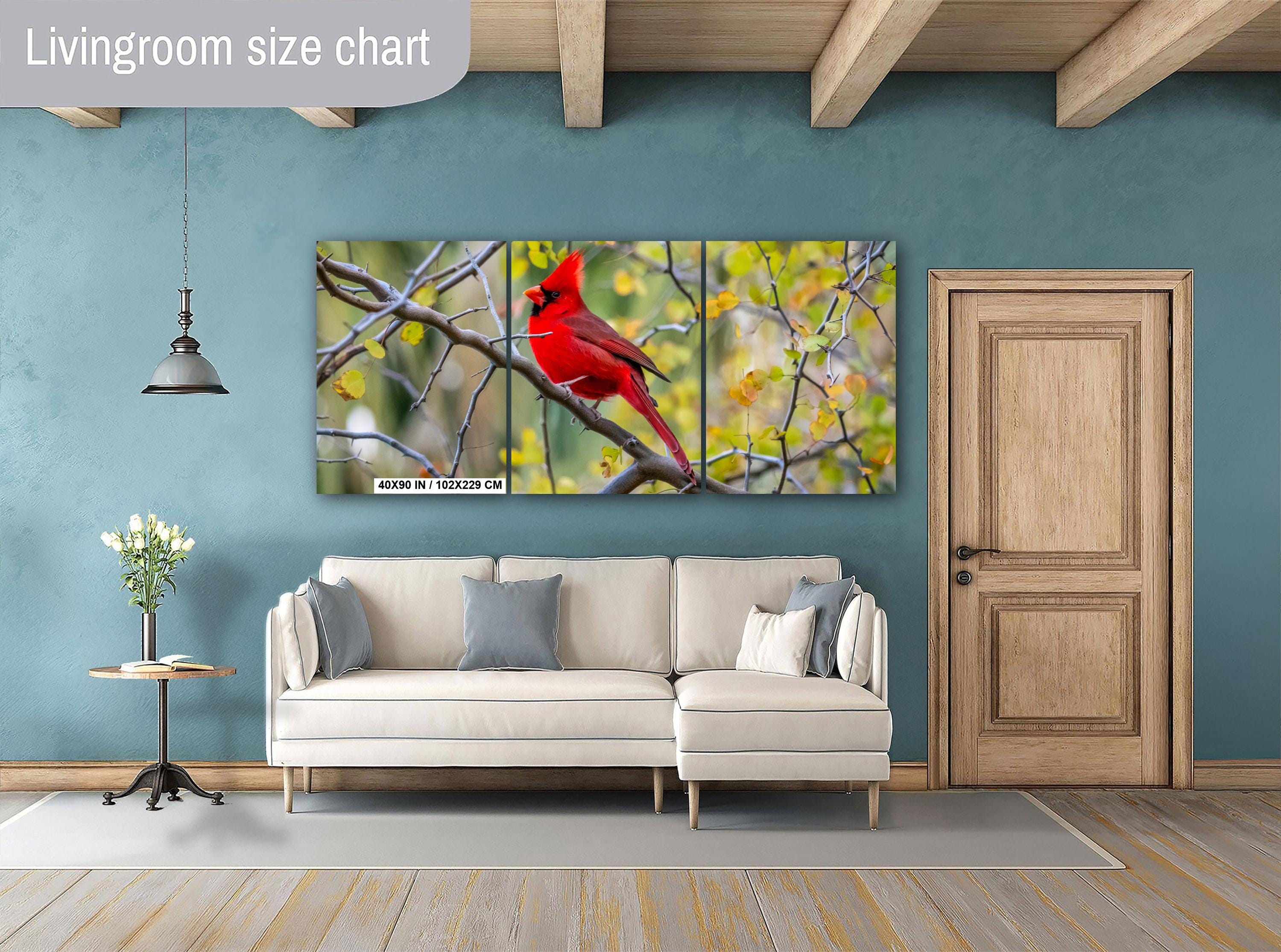 Living room with a large wall art of a red cardinal bird, beige sofa, and wooden door.