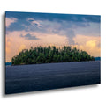 Pine island at sunset on a calm lake in Voyageurs National Park, Minnesota.