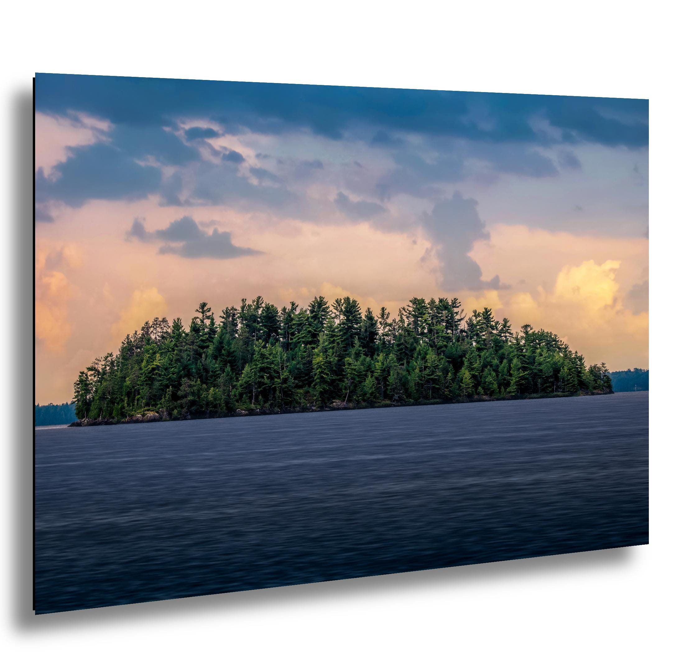 Pine island at sunset on a calm lake in Voyageurs National Park, Minnesota.