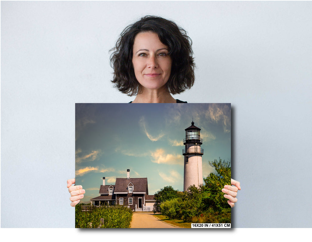 Woman holding a print of Highland Lighthouse in Cape Cod
