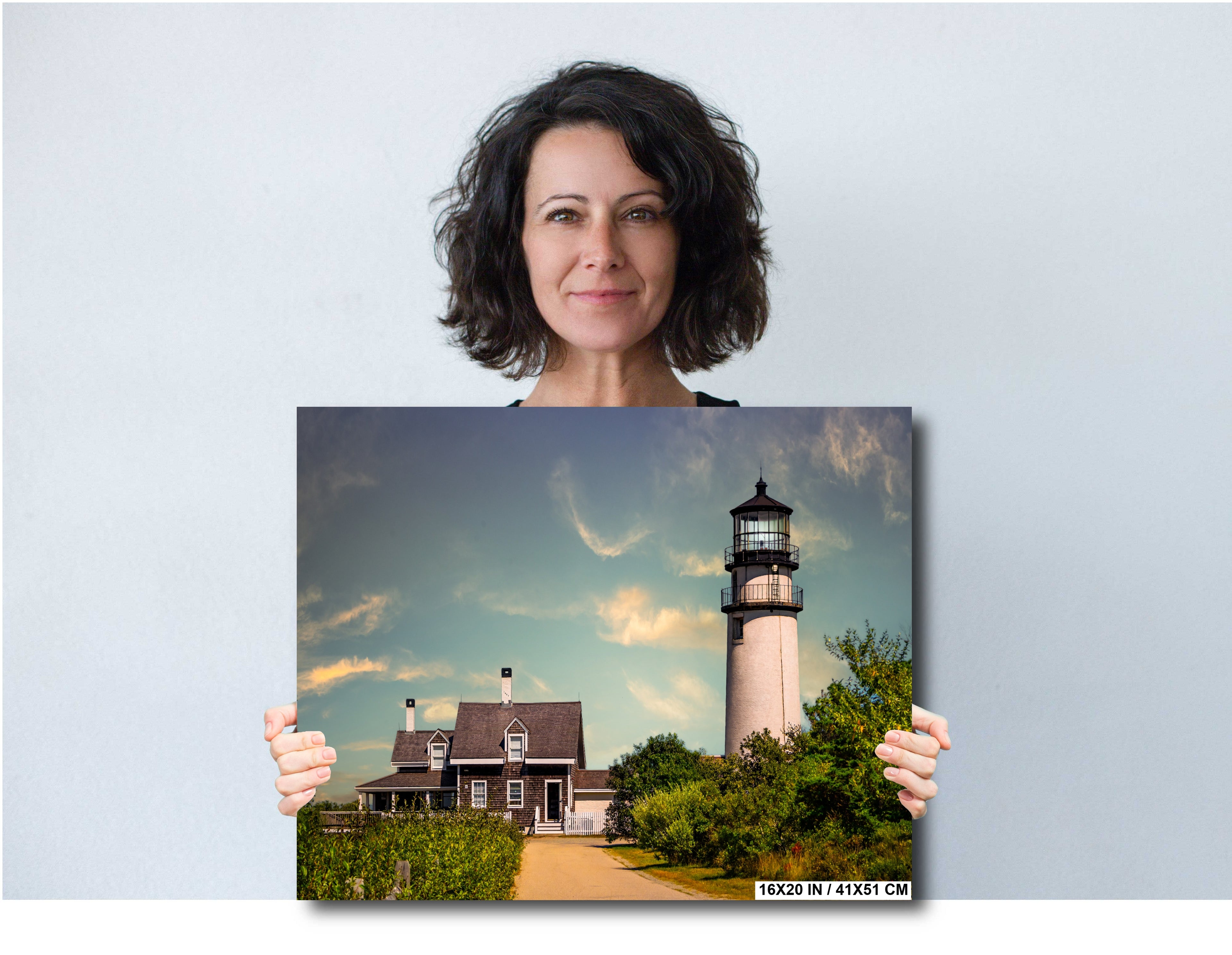 Woman holding a print of Highland Lighthouse in Cape Cod