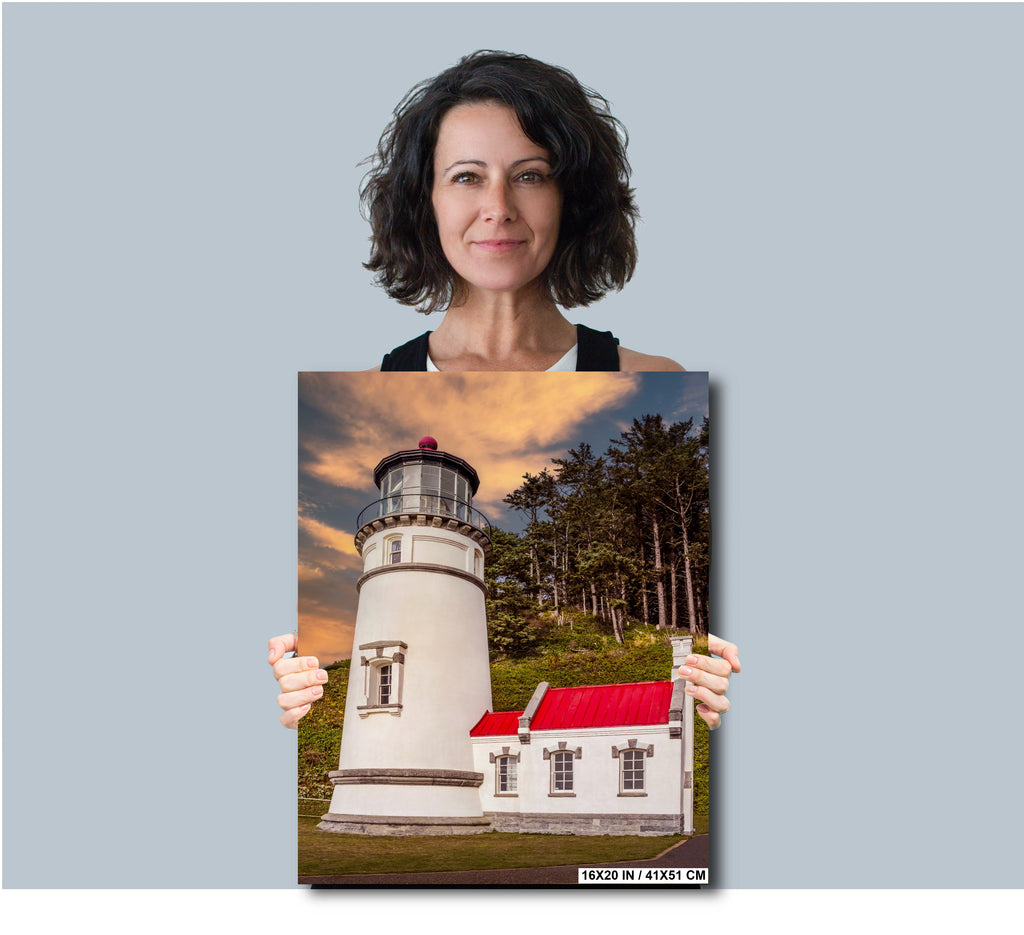 Woman holding a print of Heceta Head Lighthouse against a plain background