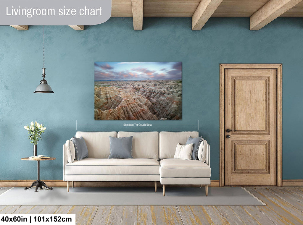 Living room with a wall art on a blue wall, beige sofa, and wooden door.