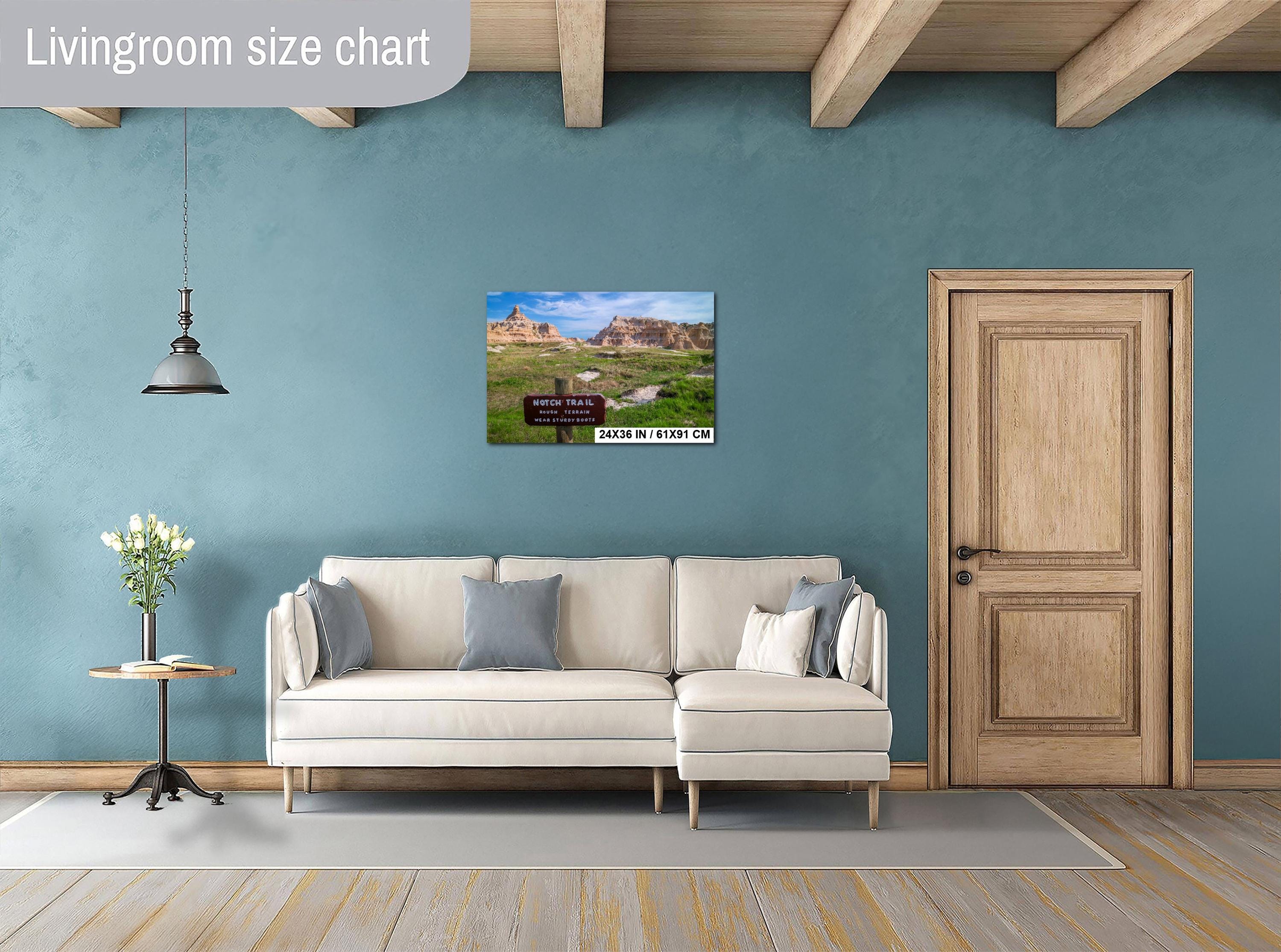 Living room with a beige sofa, decorative pillows, a small table with a plant, and a door.