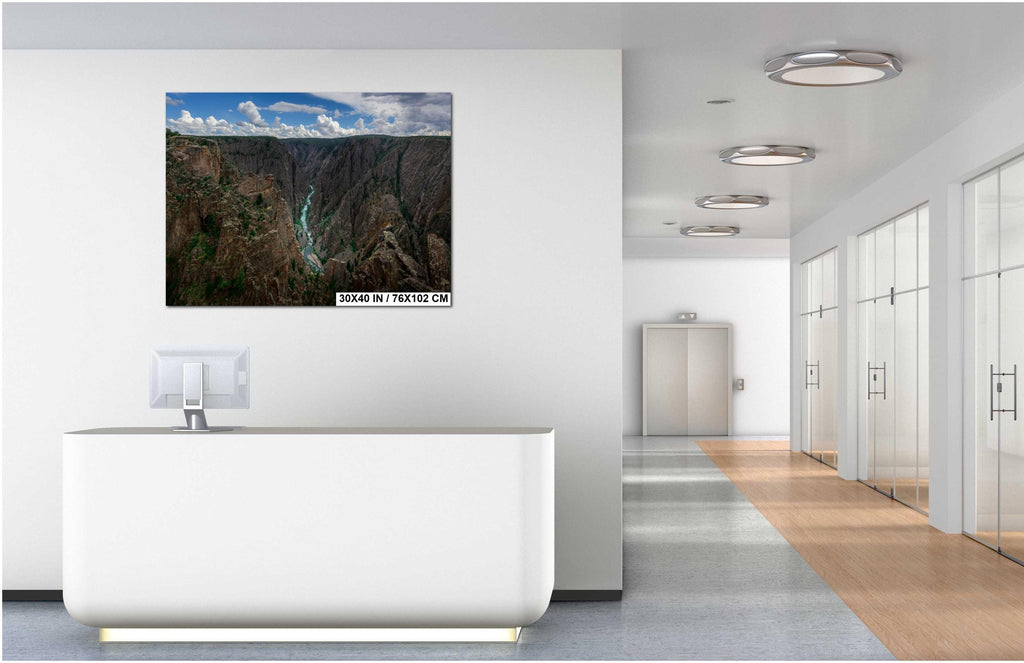 Modern office interior with a wall art displaying a mountain landscape.