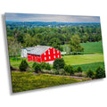 A wall art print featuring a red barn in a rural landscape with green fields and trees in McLean Farm in Adams County, Pennsylvania