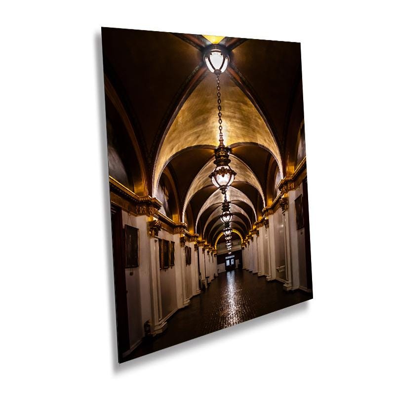 A wall art print depicting the Pennsylvania State Capitol hallway with a tunnel-like perspective, featuring arches and hanging chandeliers.