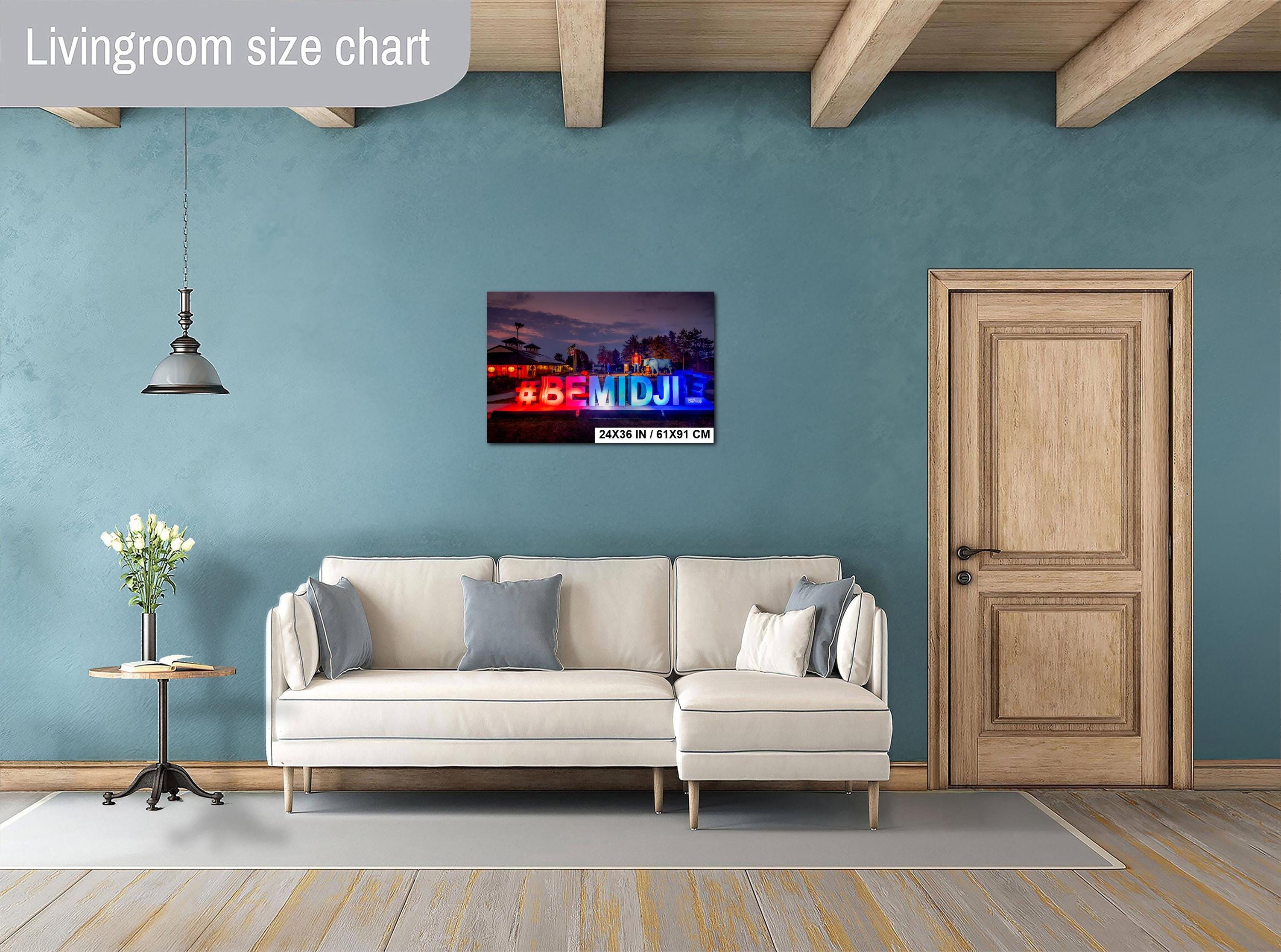 Living room with a beige sofa, decorative pillows, a small table with a plant, and a door.