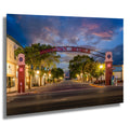 Twilight view of Downtown Bemidji archway with glowing lights and peaceful Main Street scene.