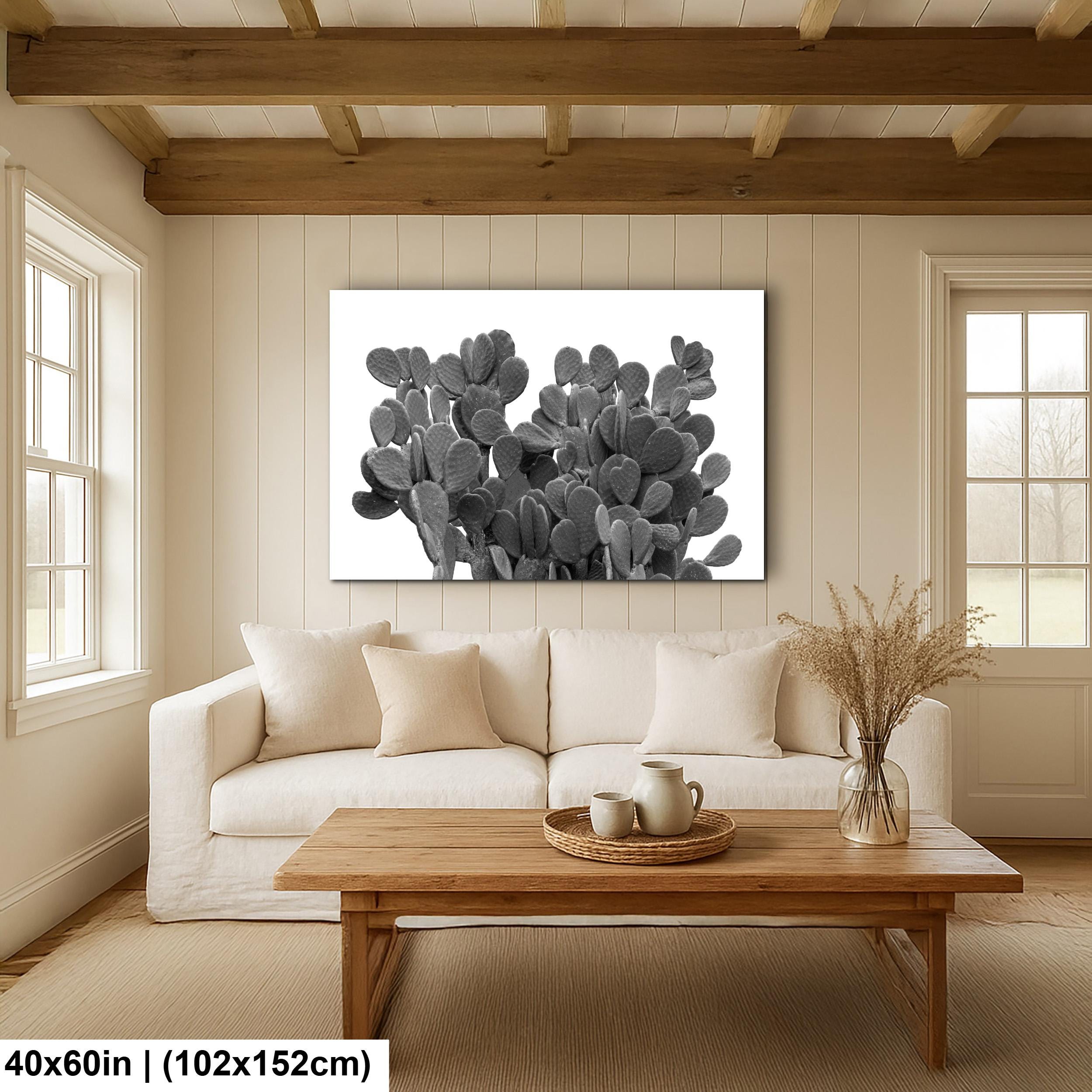Living room with a white sofa, wooden coffee table, and cactus artwork on the wall.