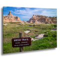 Scenic view of a rocky landscape with a 'Notch Trail' sign warning of rough terrain and stony boots.