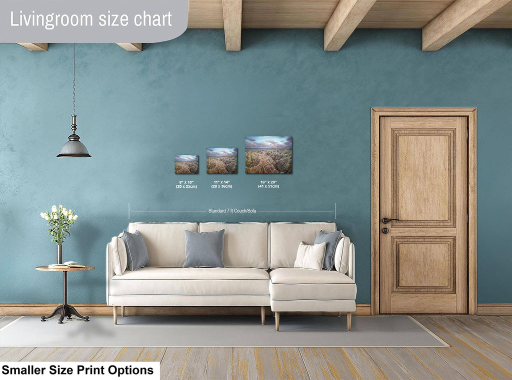 Living room with a sofa, side table, and wall art, featuring a size chart for prints.