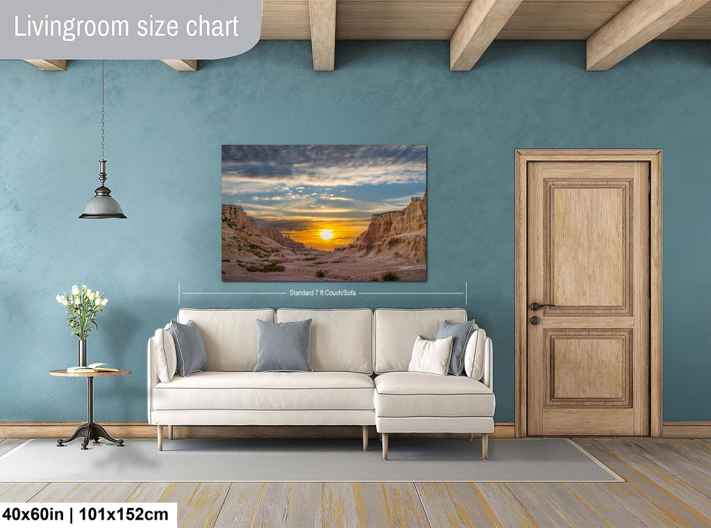 Living room with a wall art displaying a desert scene, beige sofa, and wooden door.