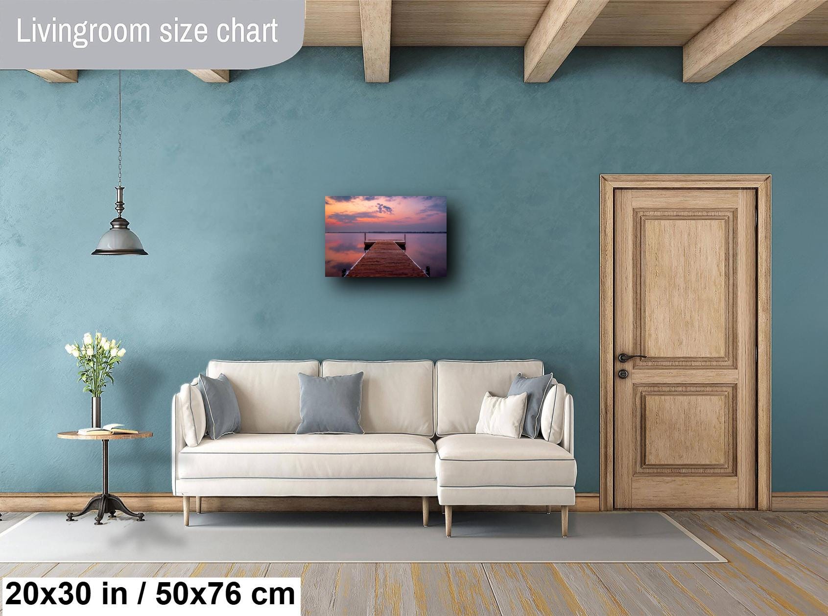 Sunset over calm Lake Bemidji with dock view and pastel skies before a summer storm wall art hanging in living room.