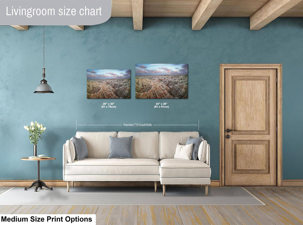 Living room with a sofa, side table, and two wall art prints on a blue wall.