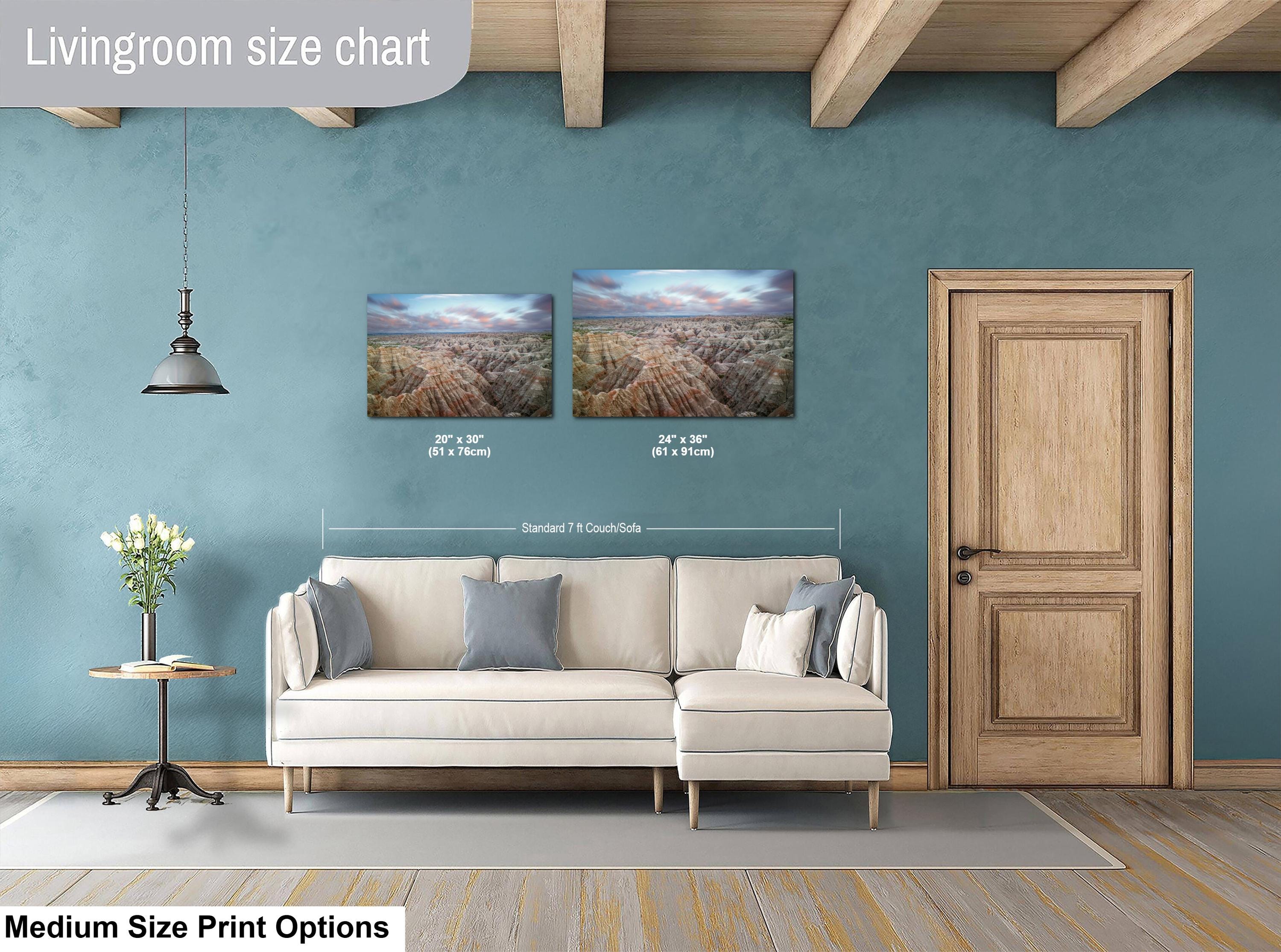 Living room with a sofa, side table, and two wall art prints on a blue wall.