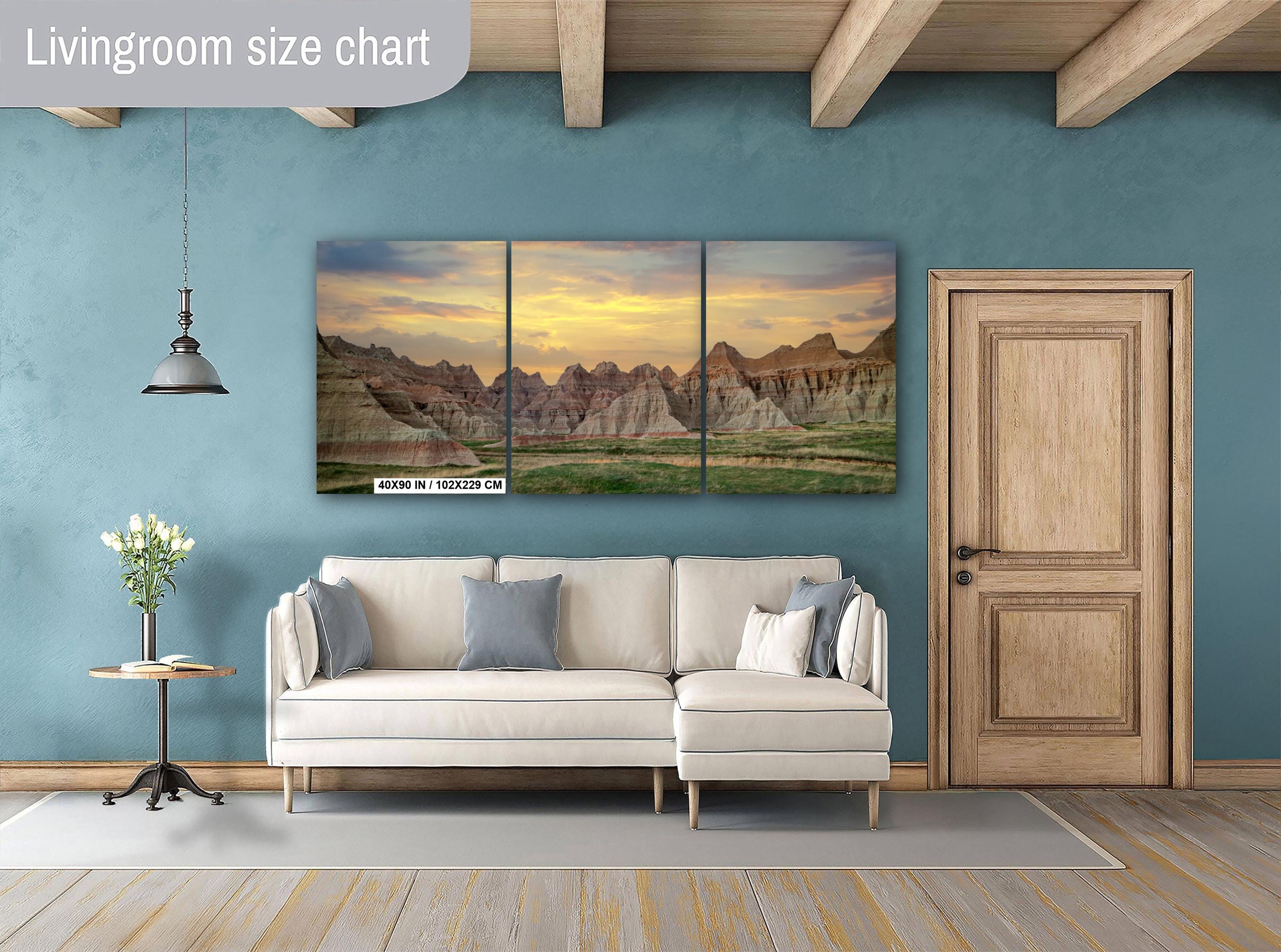 Living room with a sofa, side table, and wall art depicting a mountain landscape.