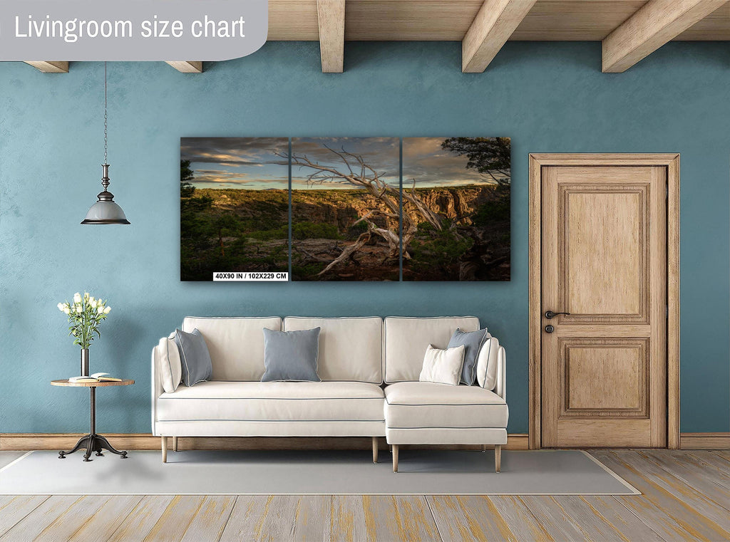 Living room with a sofa, side table, and wall art on a blue wall.