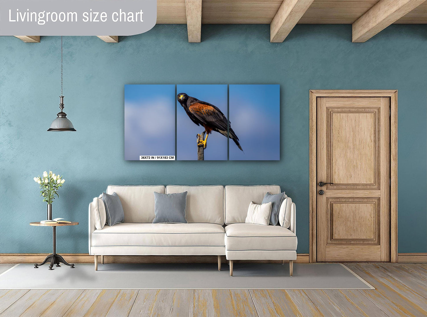 Living room with a beige sofa, decorative pillows, and a large wall art of Harris’s hawk.