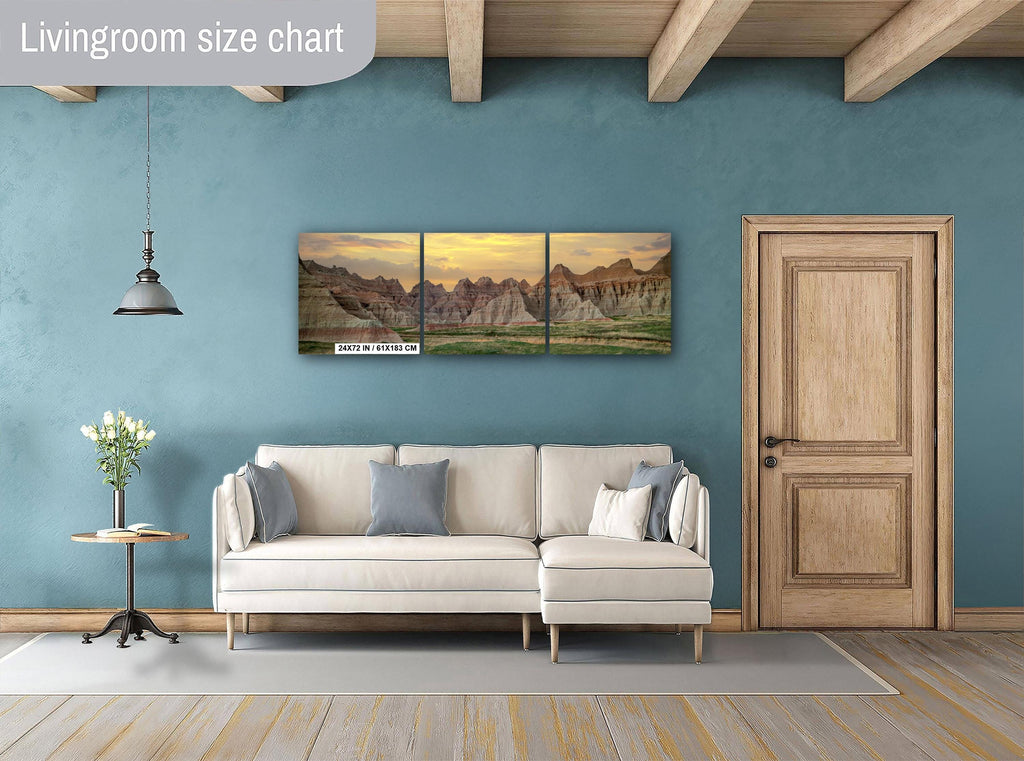 Living room with beige sofa, side table, and wall art of mountain landscape.
