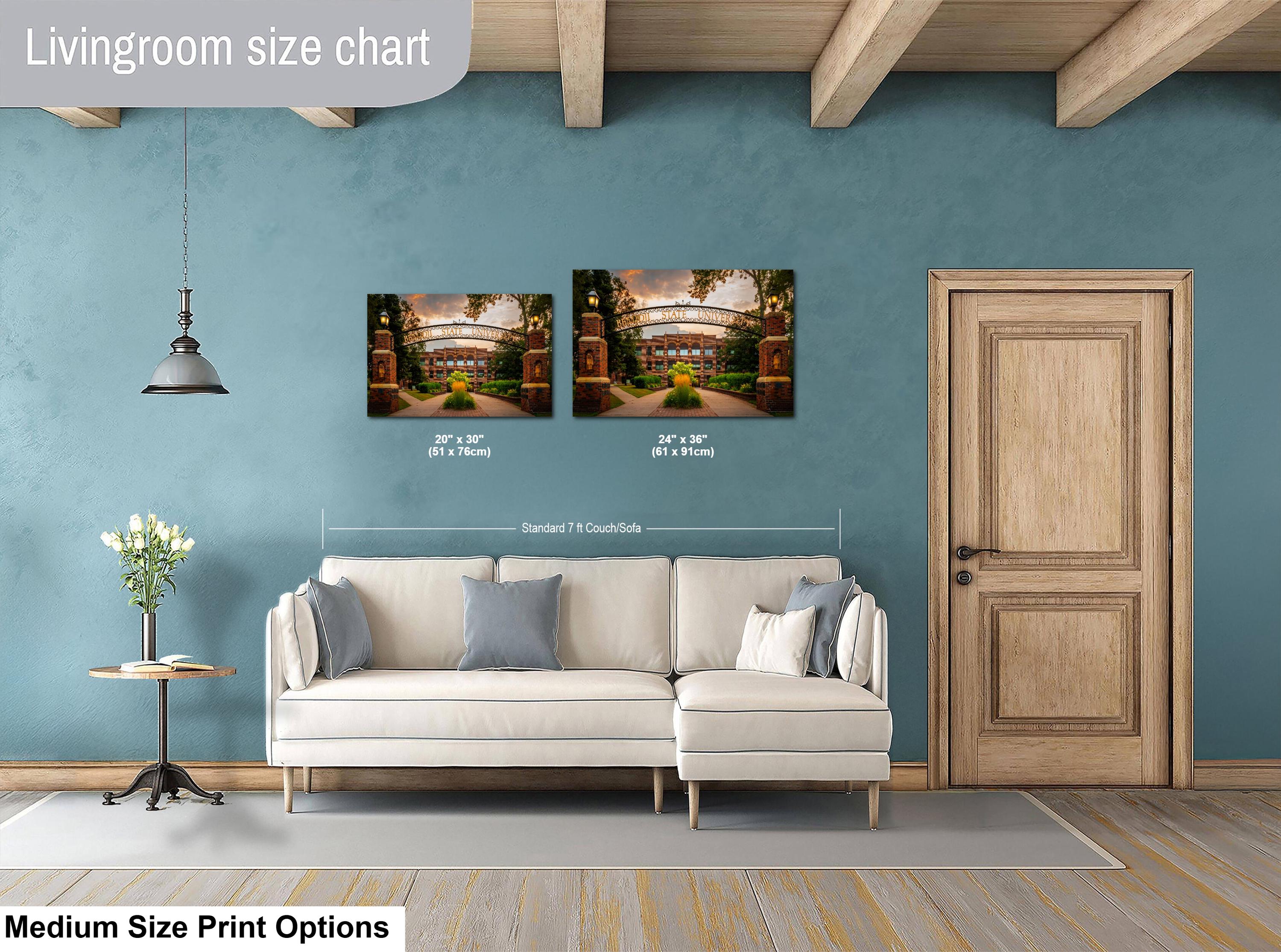 Living room with two wall art prints above a sofa, showing size chart.