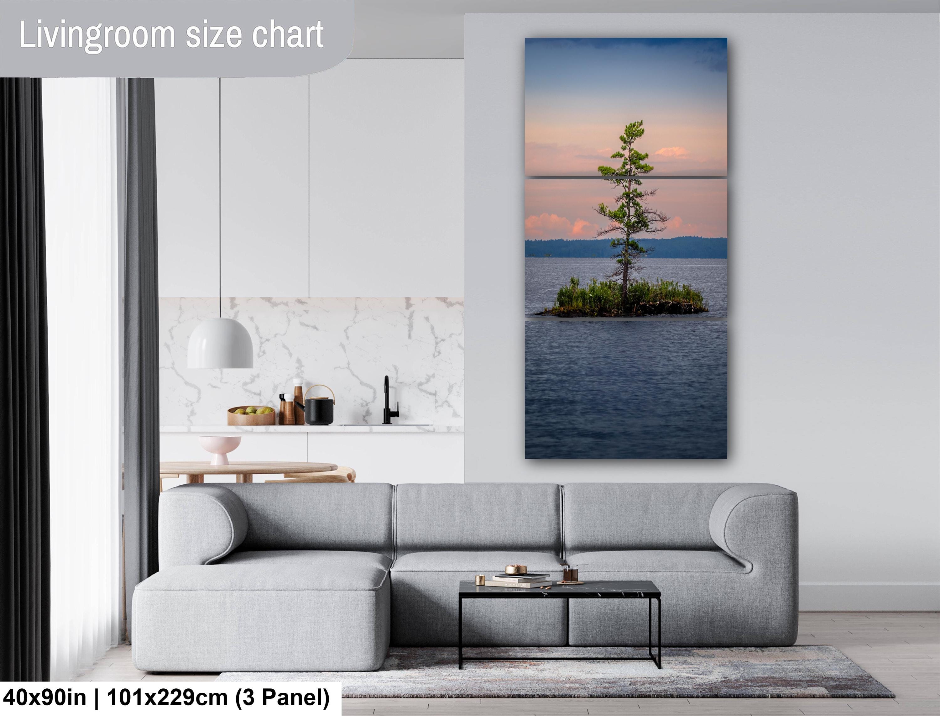 Living room with a large wall art of a lake and tree, size chart displayed.