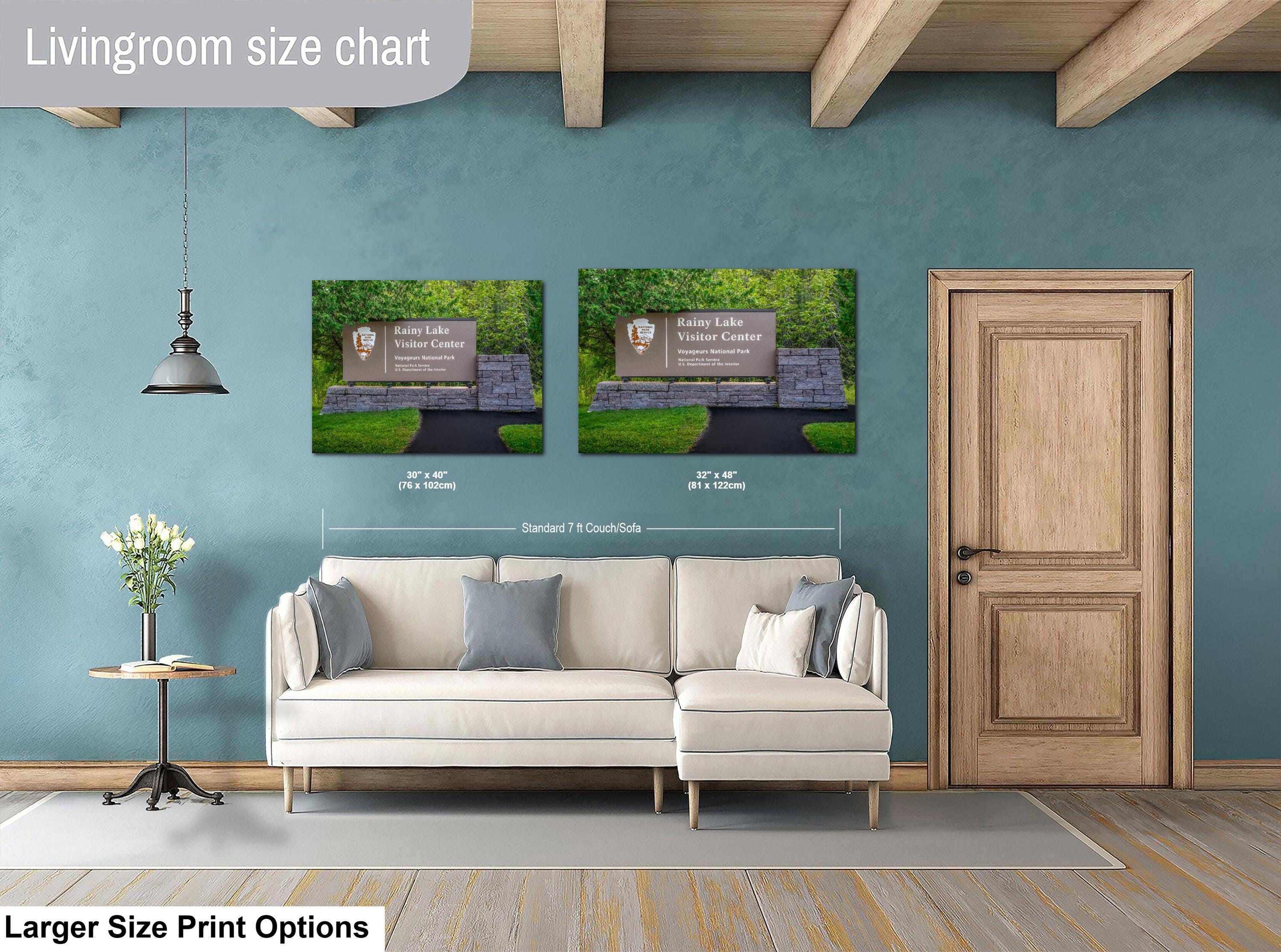 Living room with a sofa, side table, and two wall art prints on a blue wall.