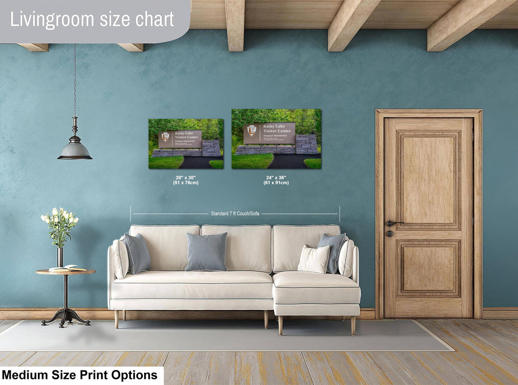 Living room with a sofa, side table, and two wall art prints on a blue wall.