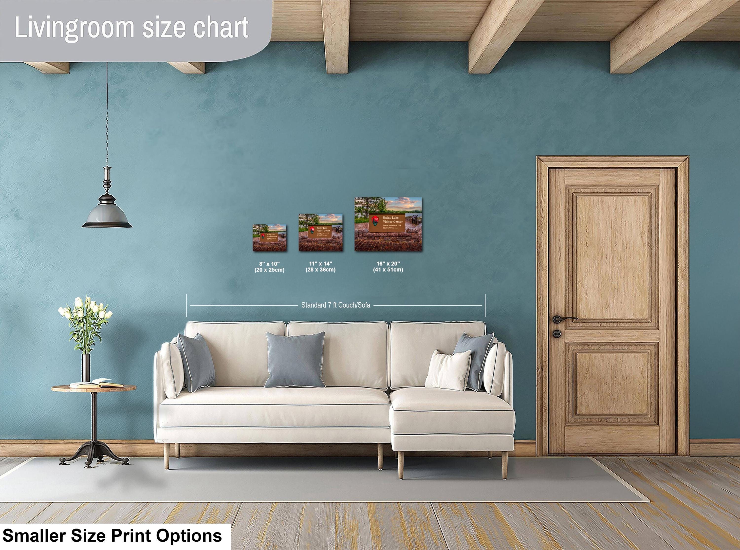 Living room with a sofa, side table, and wall art, featuring a size chart for prints.