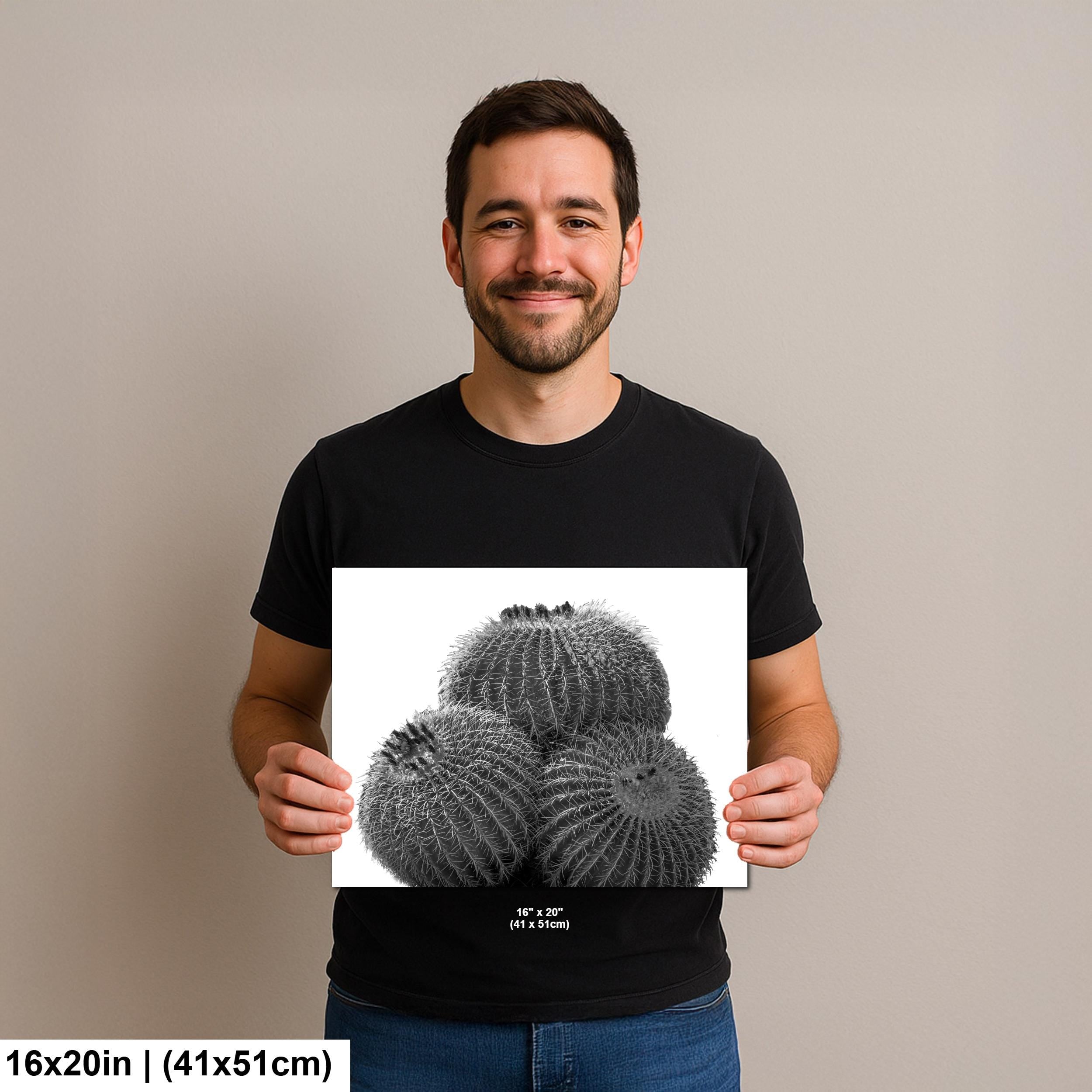 Man holding a print of a cactus with dimensions 16x20 inches on a plain background