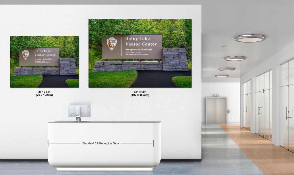 Two large wall art prints of Rainy Lake Visitor Center displayed in an office setting.