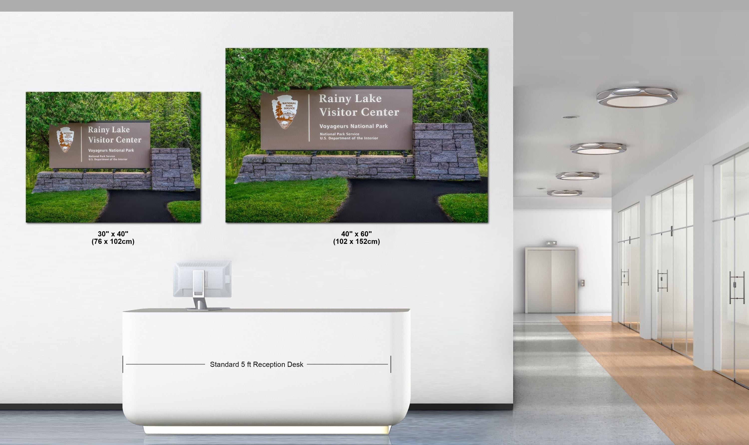 Two large wall art prints of Rainy Lake Visitor Center displayed in an office setting.
