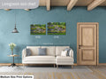 Living room with a sofa, side table, and two wall art prints on a blue wall.