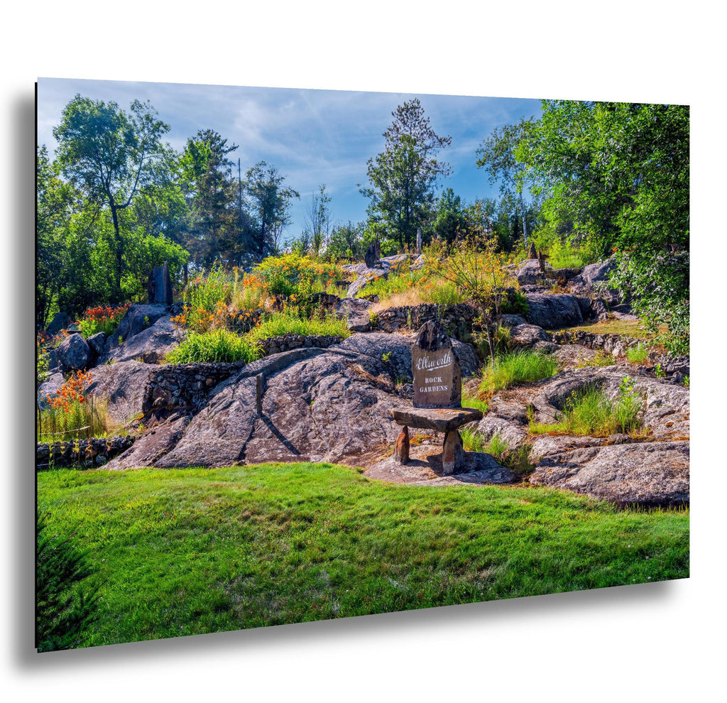 Stone marker at Ellsworth Rock Gardens with granite outcrops and wildflowers.